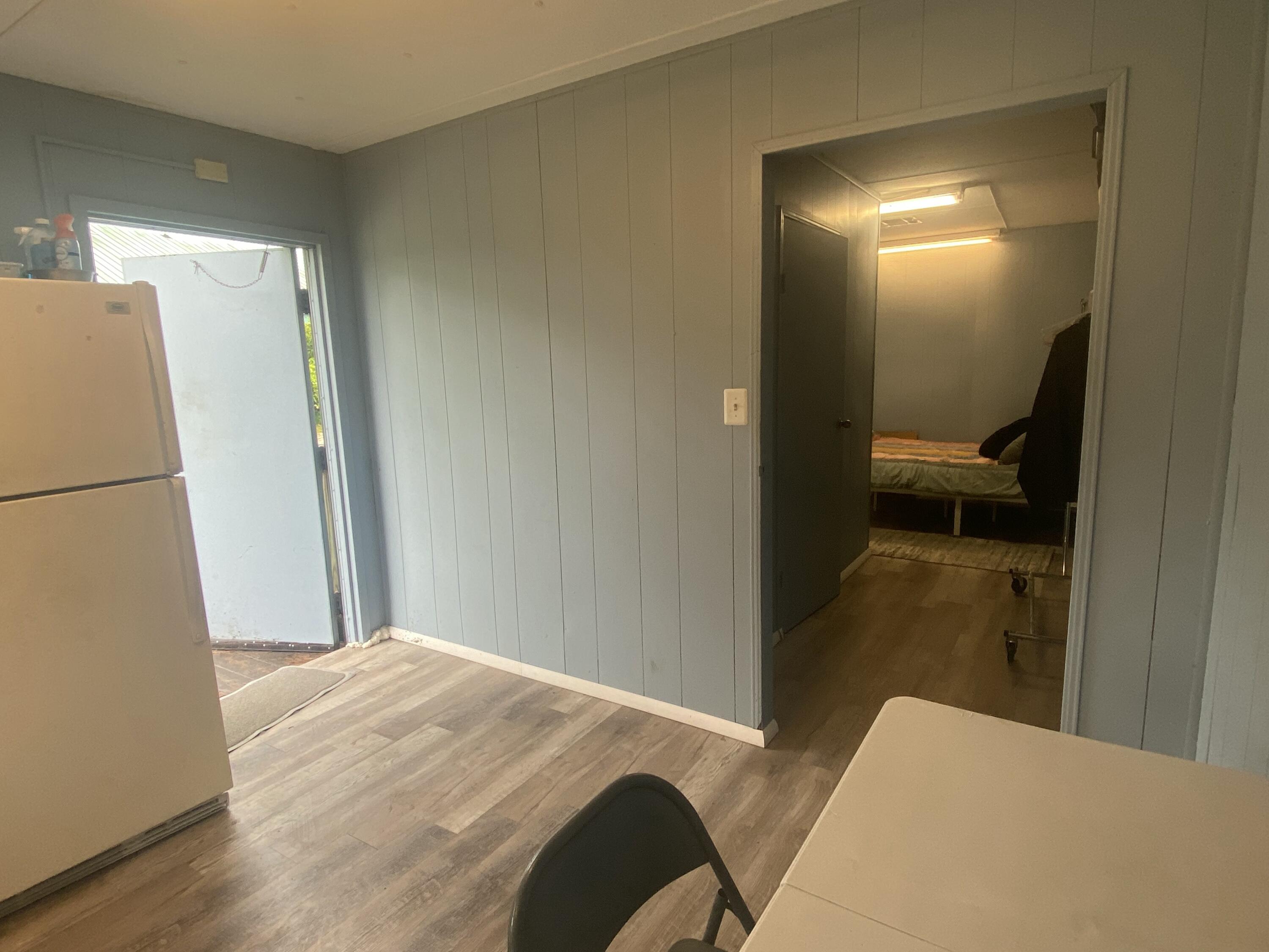 2141 B Road, Unit 4 Loxahatchee Groves, FL 33470 - Photo 5 of 43 a bedroom with a bed and a lamp