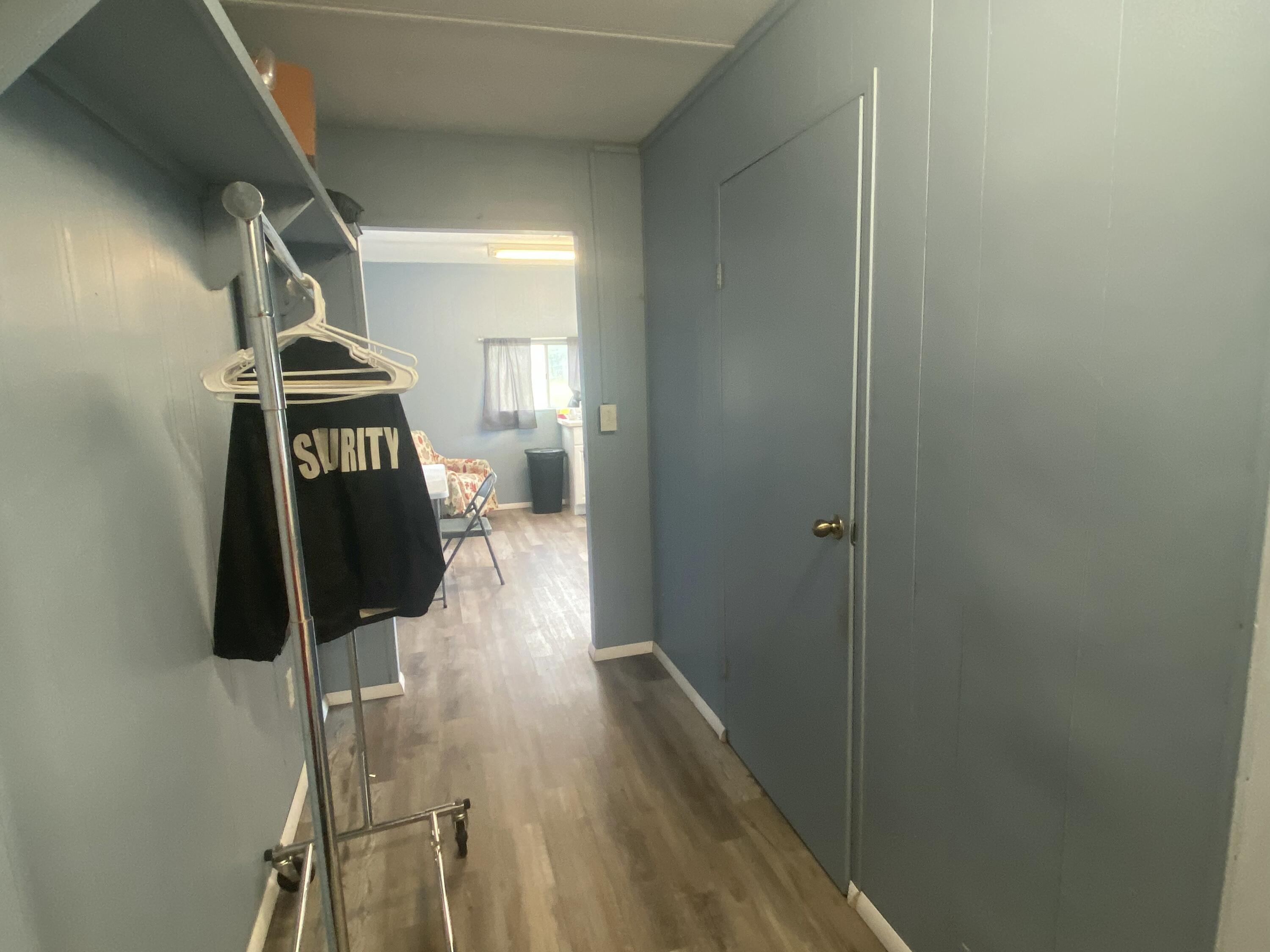 2141 B Road, Unit 4 Loxahatchee Groves, FL 33470 - Photo 6 of 43 a hallway with a wooden floor