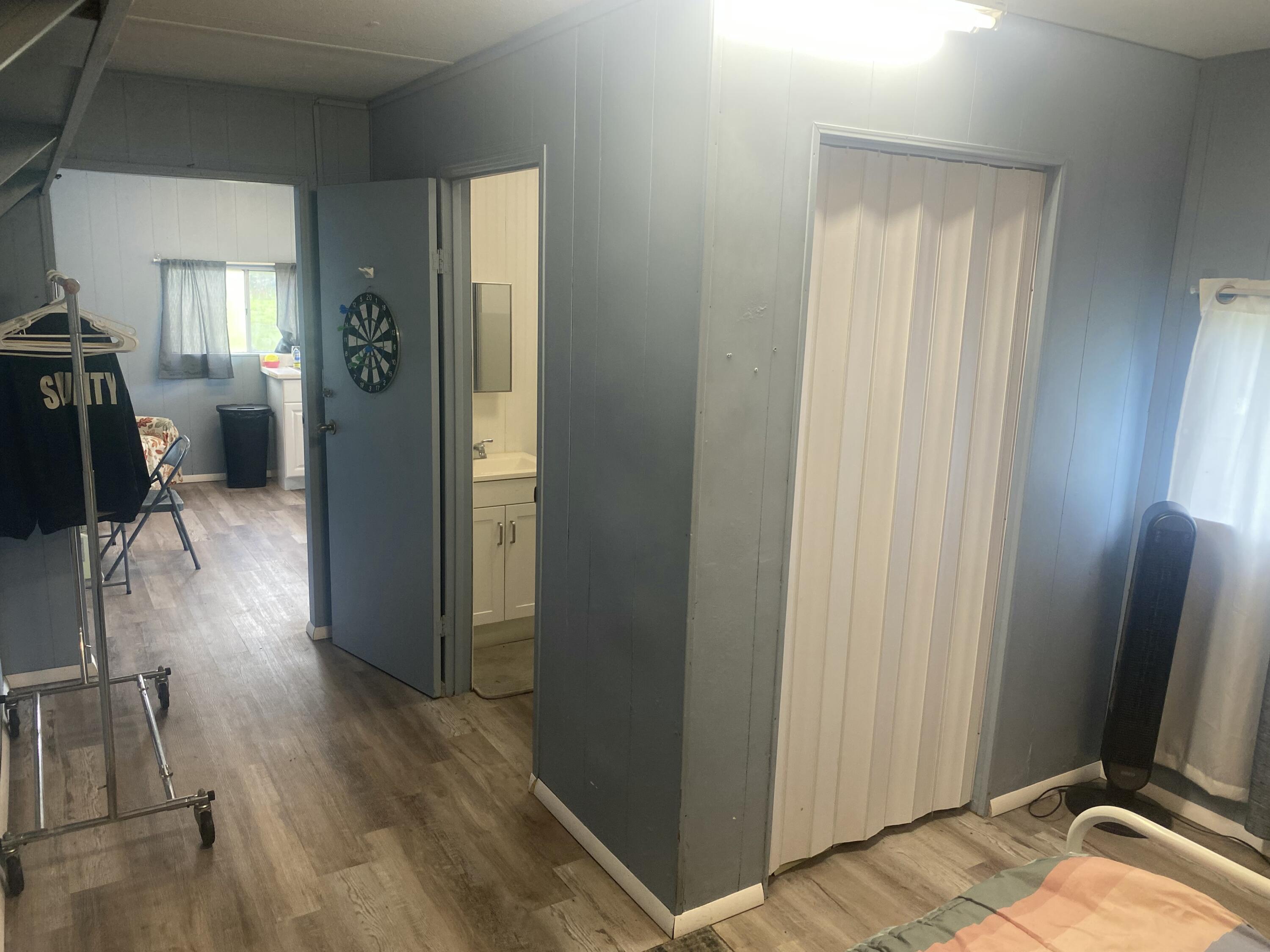 2141 B Road, Unit 4 Loxahatchee Groves, FL 33470 - Photo 7 of 43 a view of a hallway with wooden floor