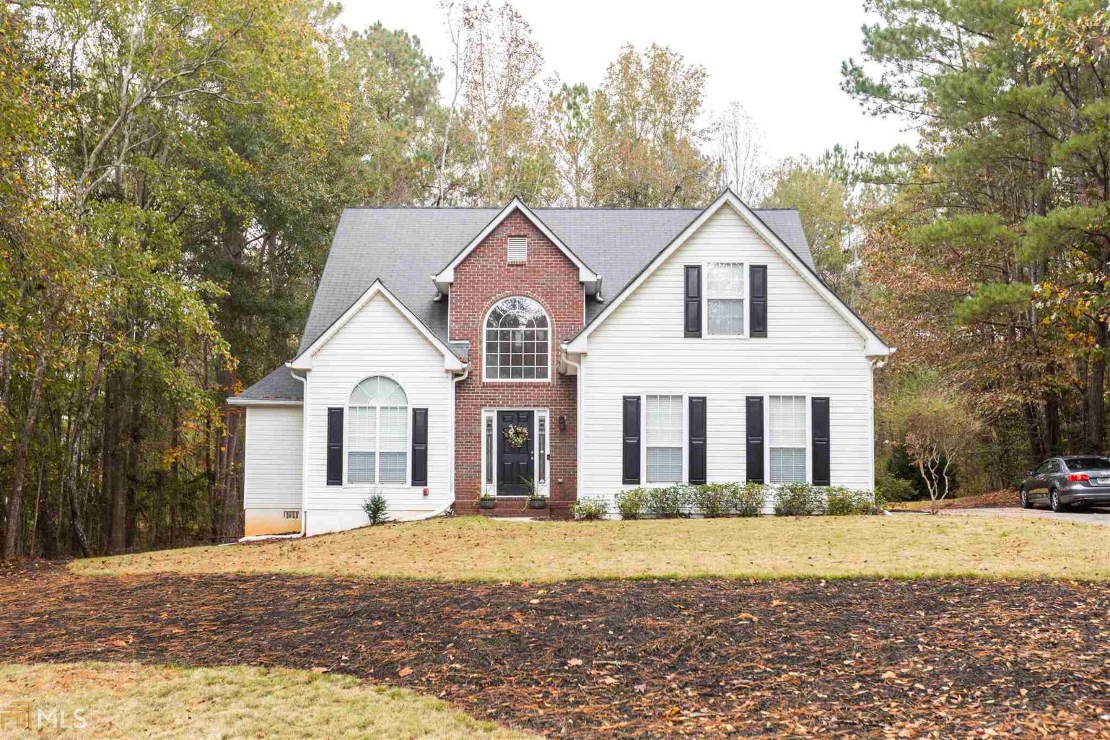 a front view of a house with a yard