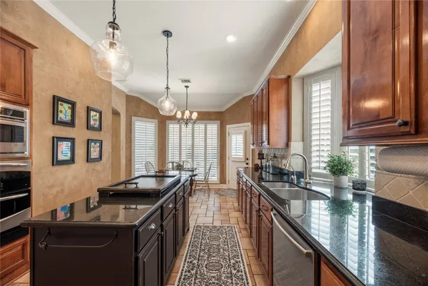 a view of a dining room with furniture and chandelier