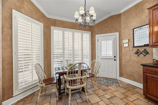a kitchen with granite countertop a sink a counter space appliances and cabinets