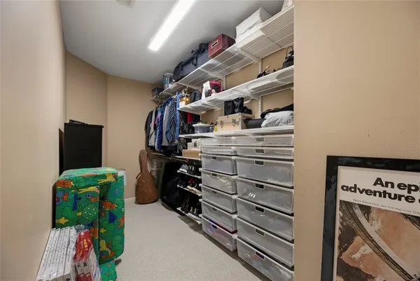 a bedroom with a bed couch and a window
