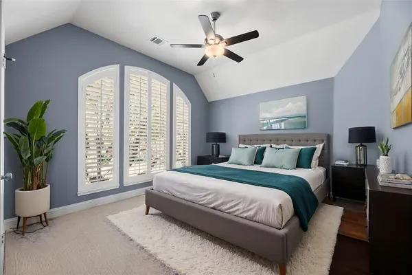 an empty room with windows and fan