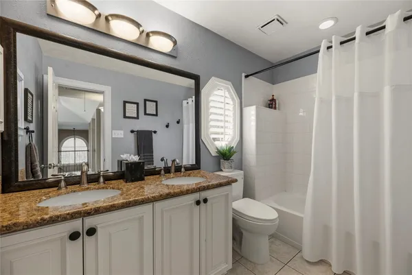 a living room with furniture pool table and windows