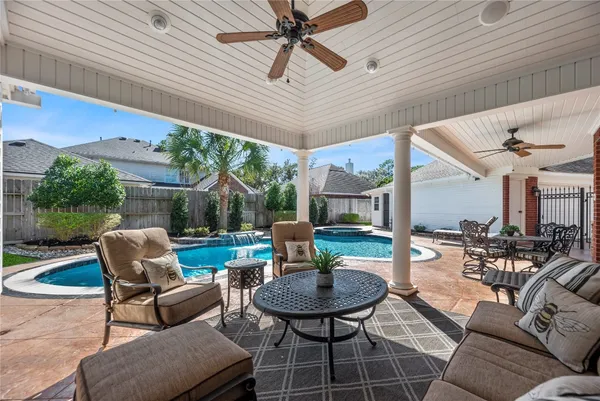 a view of a house with swimming pool and porch with furniture