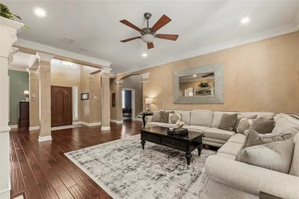 a living room with furniture and wooden floor