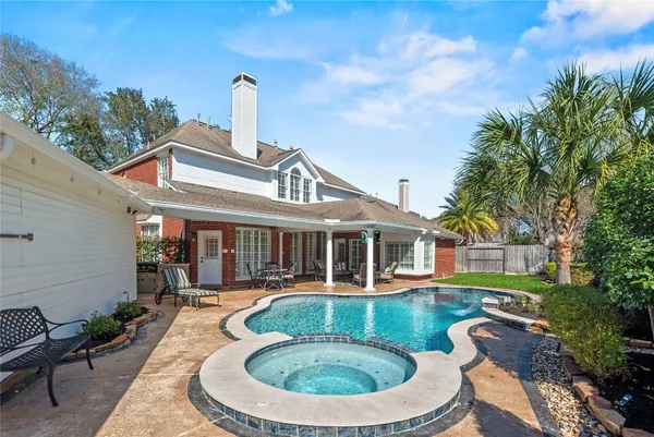 a kitchen with stainless steel appliances granite countertop a sink and a white cabinets
