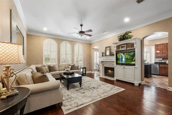 a living room with furniture a fireplace and a flat screen tv
