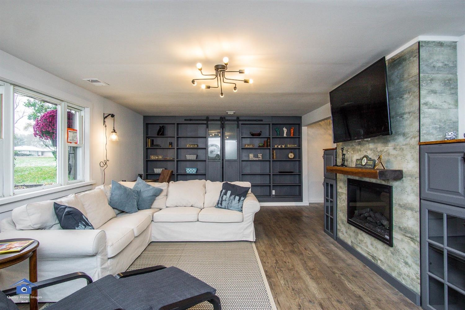 10807 Porter Street Crown Point, IN 46307 - Photo 5 of 10 a living room with furniture a fireplace and a flat screen tv