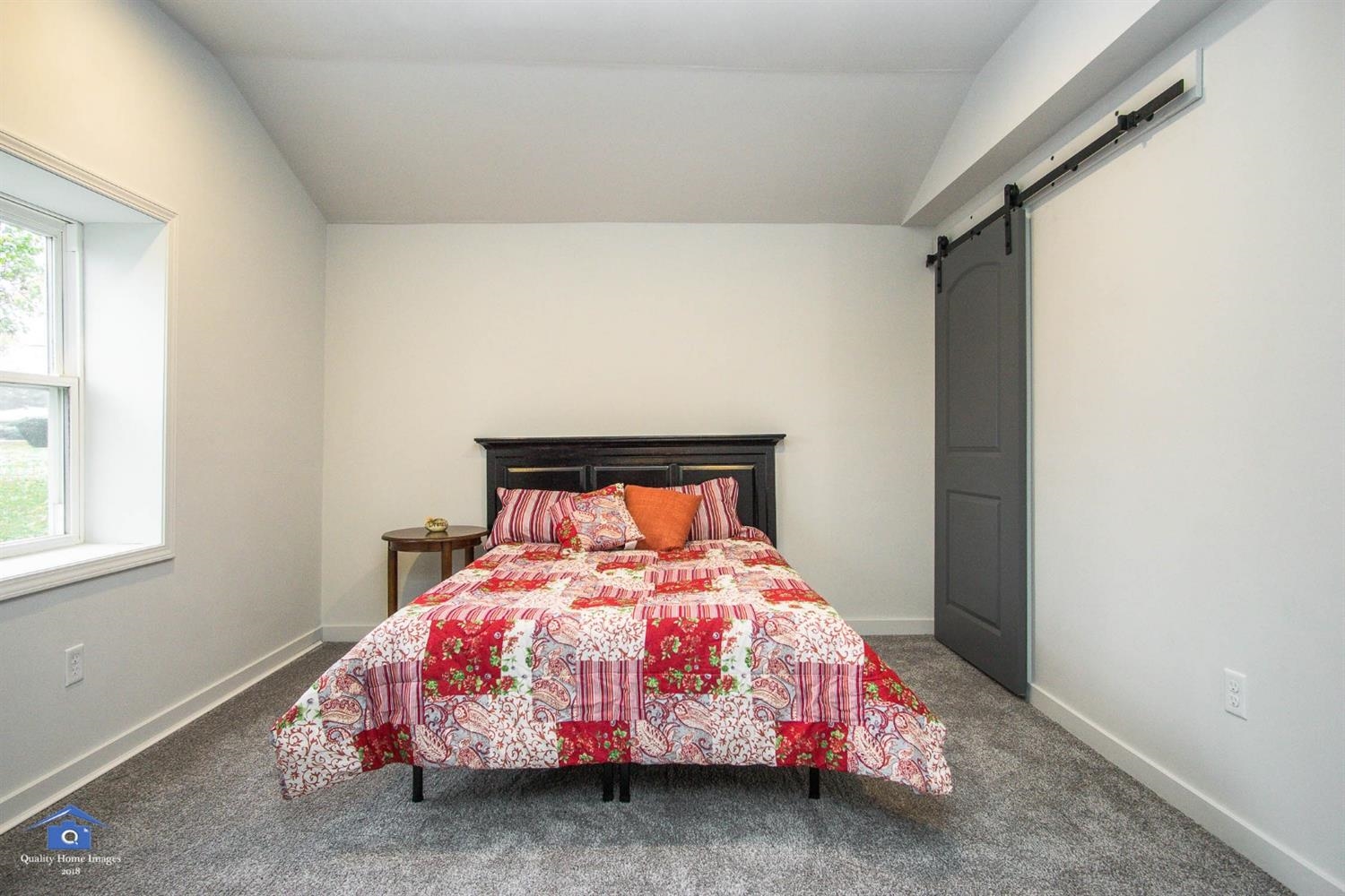 10807 Porter Street Crown Point, IN 46307 - Photo 8 of 10 a bedroom with a bed and a window