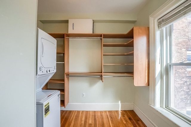 a view of walk in closet with empty racks