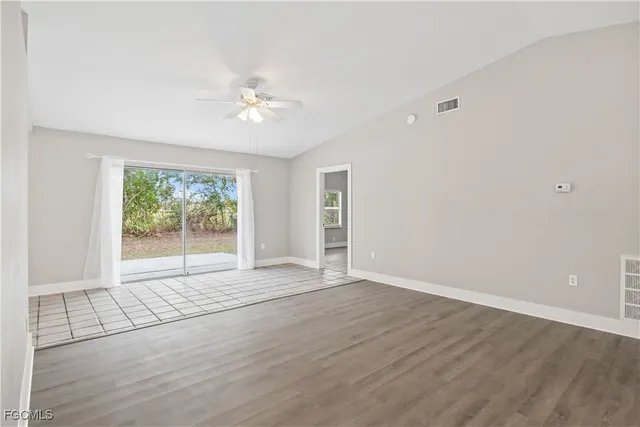 wooden floor in an empty room with a window