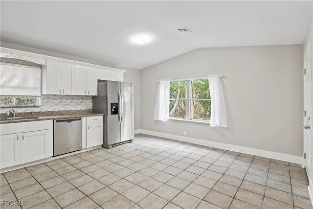 a kitchen with a sink cabinets and window