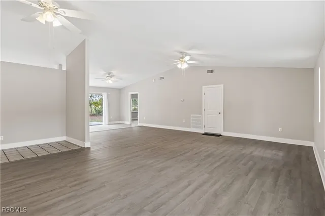 a view of an empty room with wooden floor