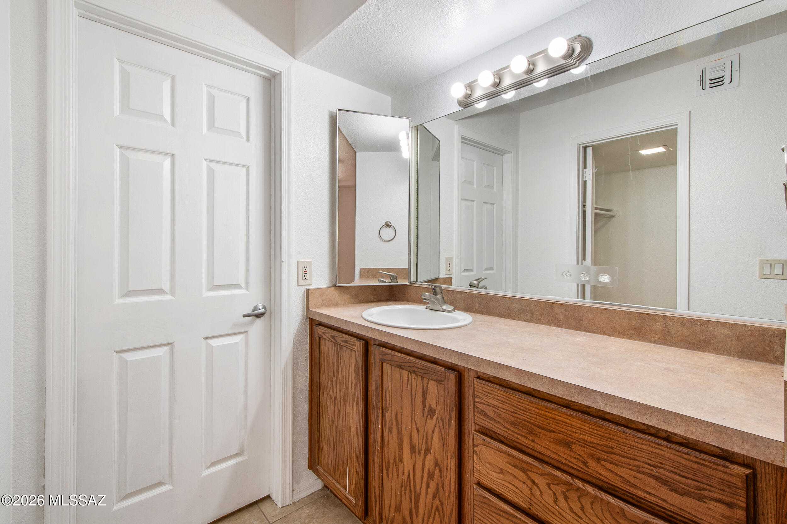 5855 North Kolb Road, Unit 6103 Tucson, AZ 85750 - Photo 11 of 31 a bathroom with a sink and a mirror