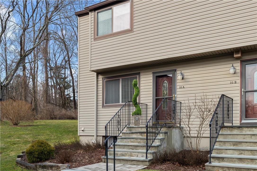 10 Squires Gate, Unit A Poughkeepsie, NY 12603 - Photo 1 of 1 a front view of a house with garden