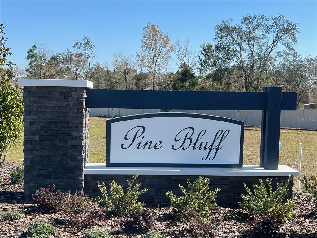 4922 Sutherland St Spring Hill, Unit LOT 68 Spring Hill, FL 34609 - Photo 3 of 3 a sign broad in front of the red brick house