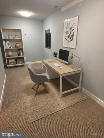 a workspace with furniture and painting on the wall