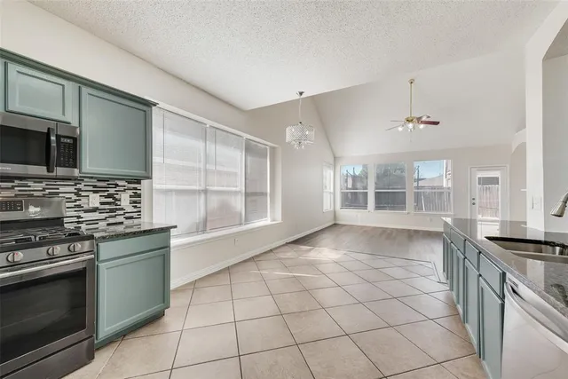 a large white kitchen with cabinets