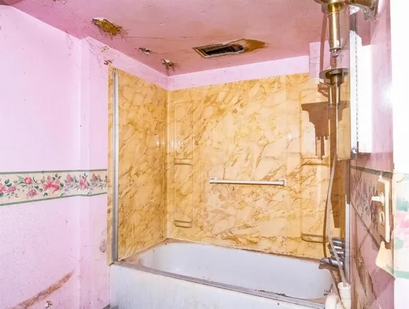 a bathroom with a bathtub and shower