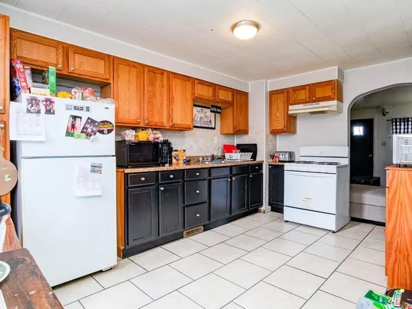 a kitchen with a stove a refrigerator and a sink