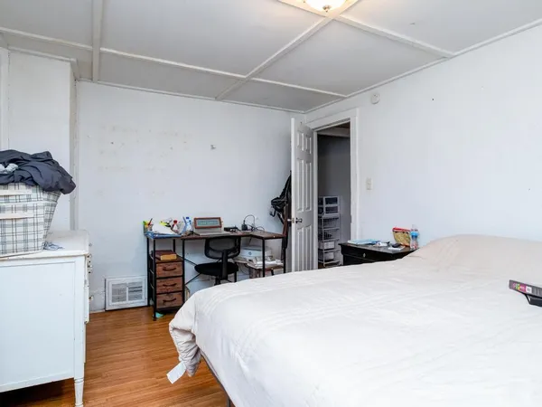 a bed room with a bed and a chair