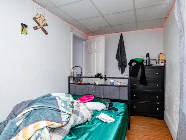 a bedroom with a bed and a dresser