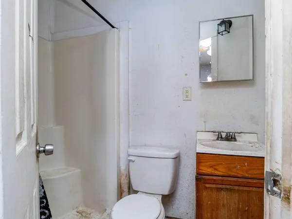 a white toilet sitting next to a bathroom sink