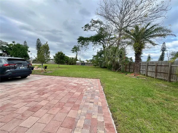 a view of a yard and car parked
