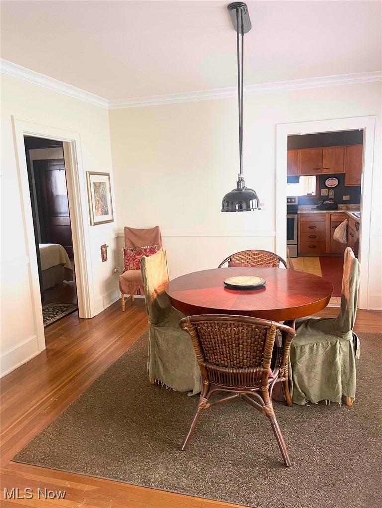 1302 Waverly Road Sandusky, OH 44870 - Photo 5 of 13 Dining area featuring ornamental molding and dark hardwood / wood-style floors
