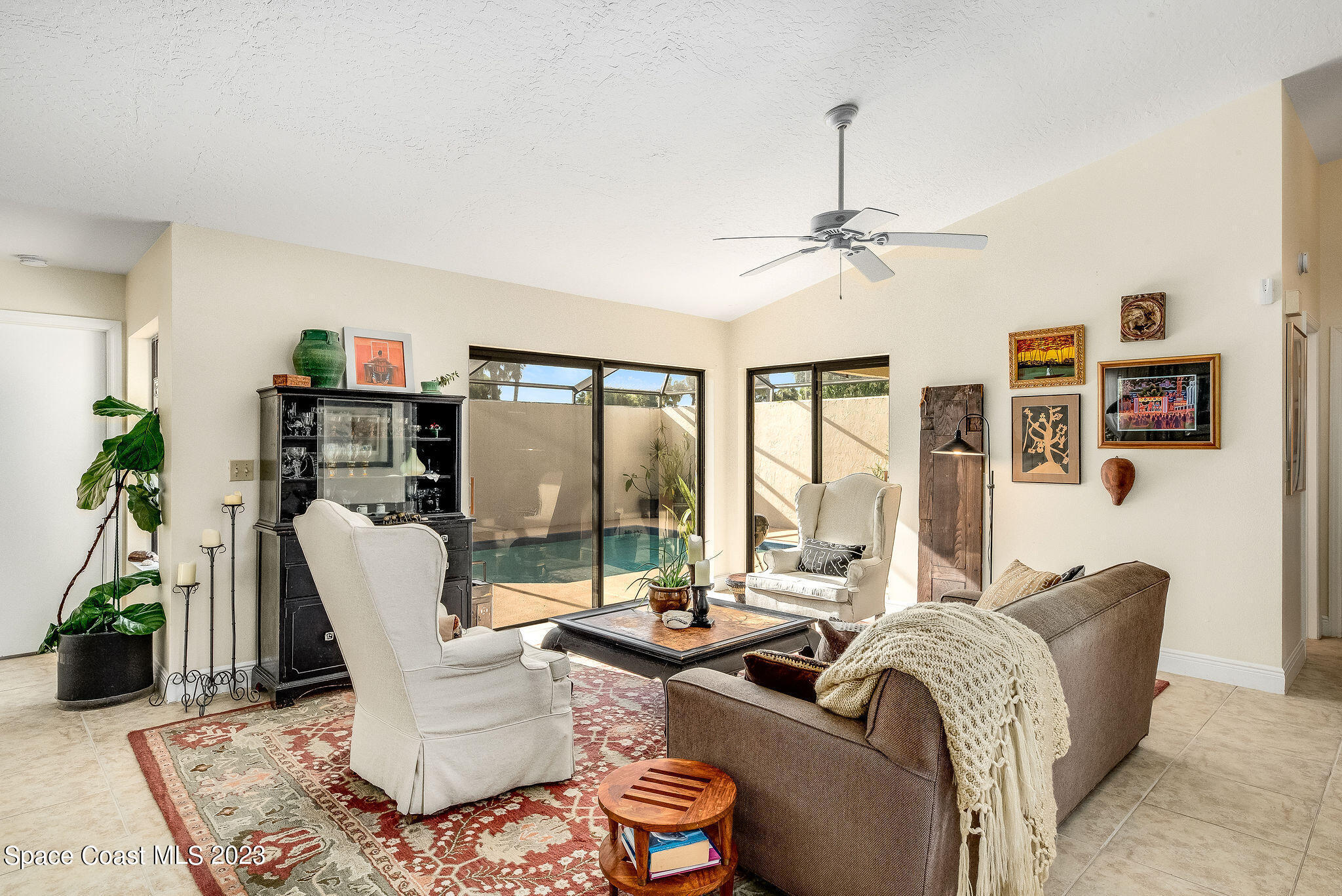 440 Maple Bluff Circle Melbourne, FL 32940 - Photo 15 of 92 a living room with furniture and a floor to ceiling window