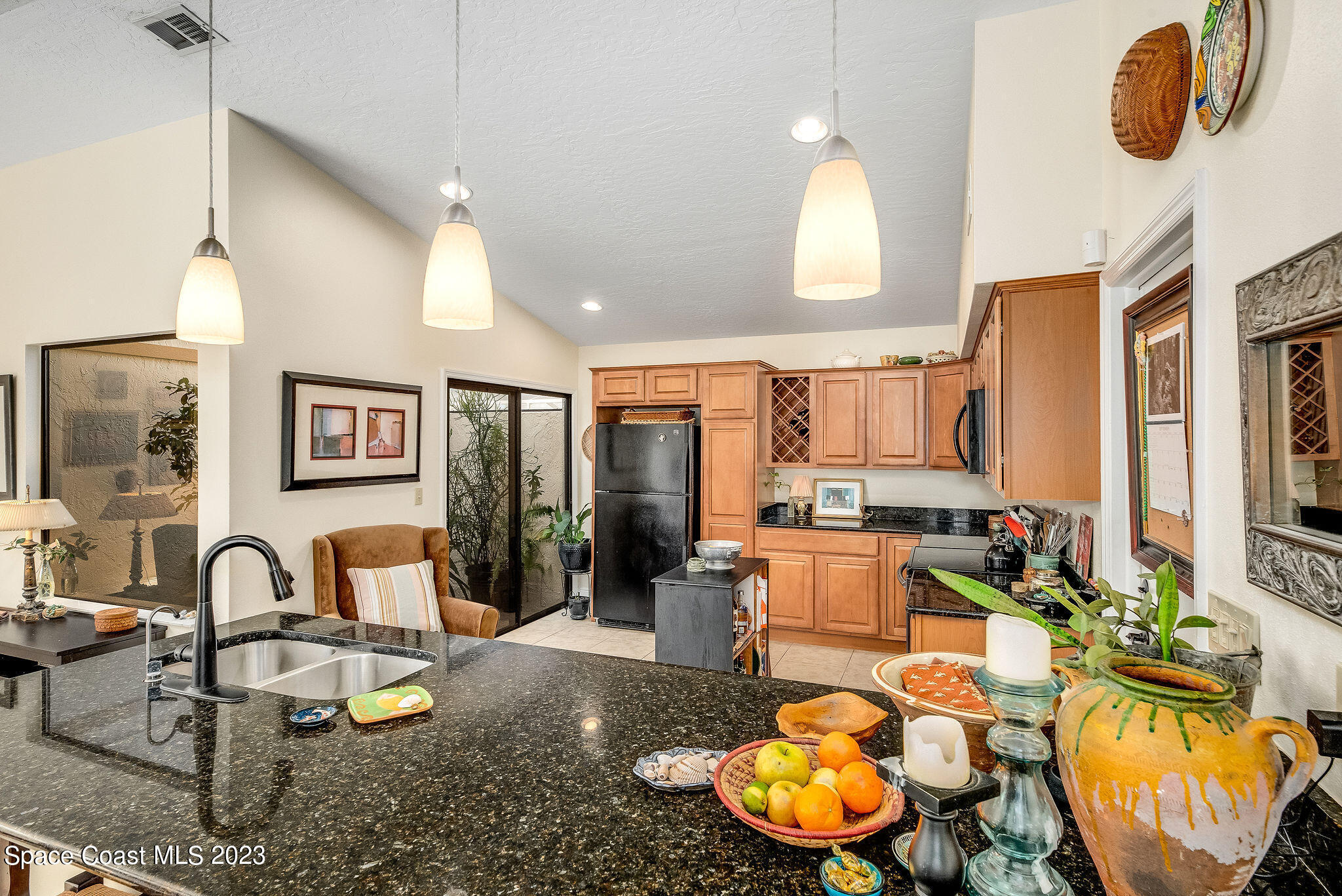 440 Maple Bluff Circle Melbourne, FL 32940 - Photo 19 of 92 a living room with furniture a rug and a large window