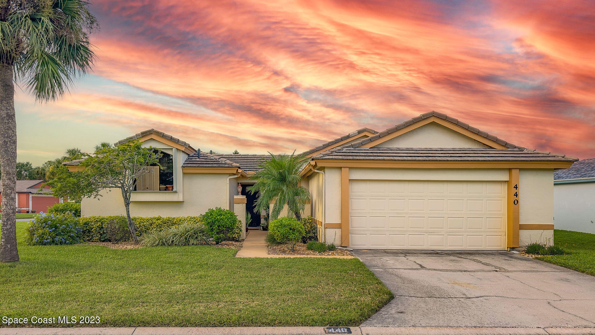 440 Maple Bluff Circle Melbourne, FL 32940 - Photo 2 of 92 a front view of a house with a yard and garage
