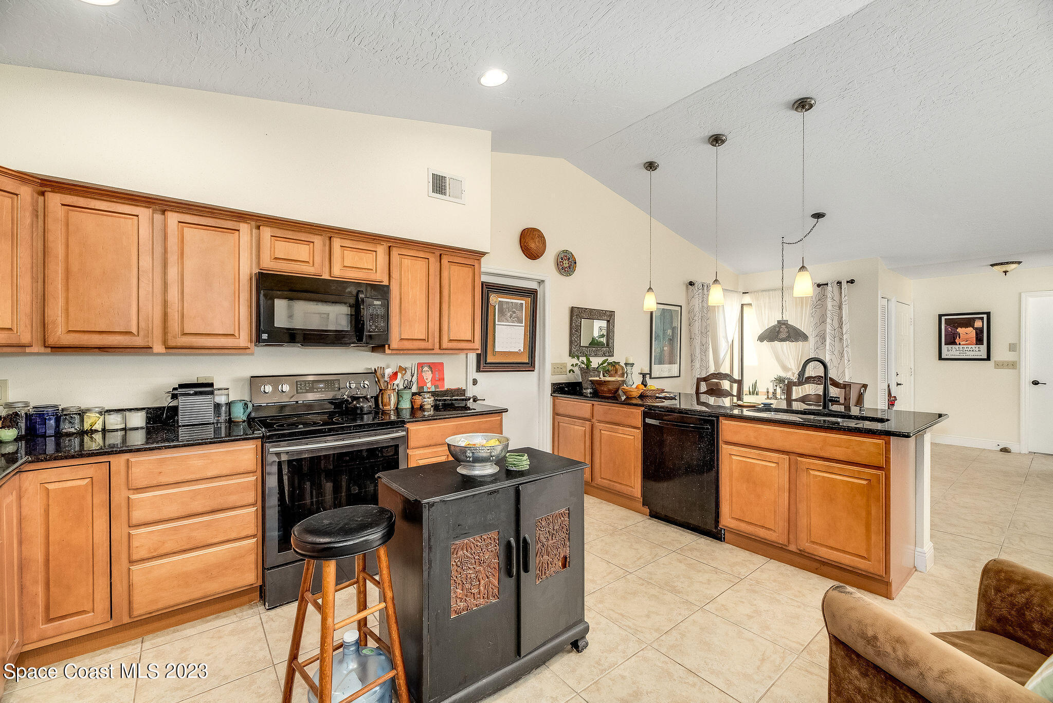 440 Maple Bluff Circle Melbourne, FL 32940 - Photo 24 of 92 a kitchen with stainless steel appliances granite countertop a stove top oven a sink dishwasher and a refrigerator with wooden cabinets