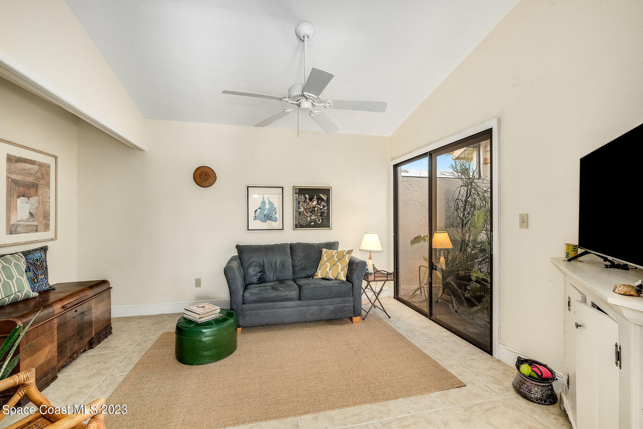 440 Maple Bluff Circle Melbourne, FL 32940 - Photo 25 of 92 a living room with furniture and a flat screen tv