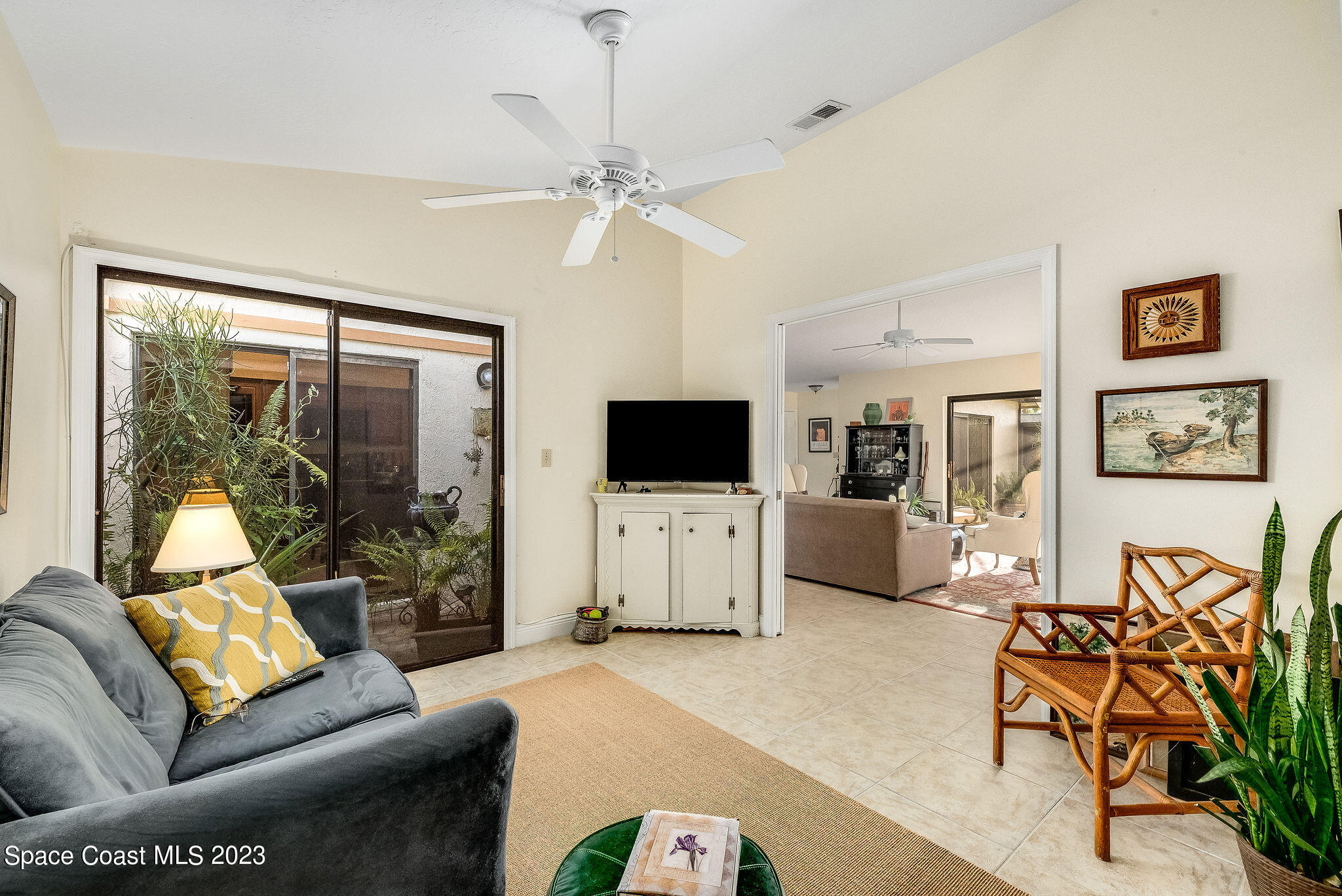 440 Maple Bluff Circle Melbourne, FL 32940 - Photo 26 of 92 a living room with furniture and a flat screen tv