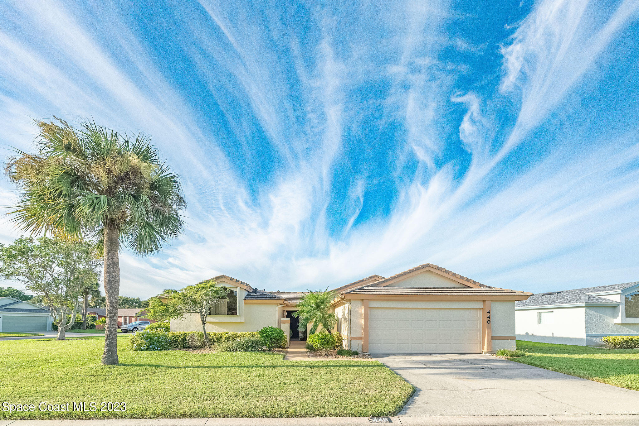 440 Maple Bluff Circle Melbourne, FL 32940 - Photo 3 of 92 a front view of a house with garden