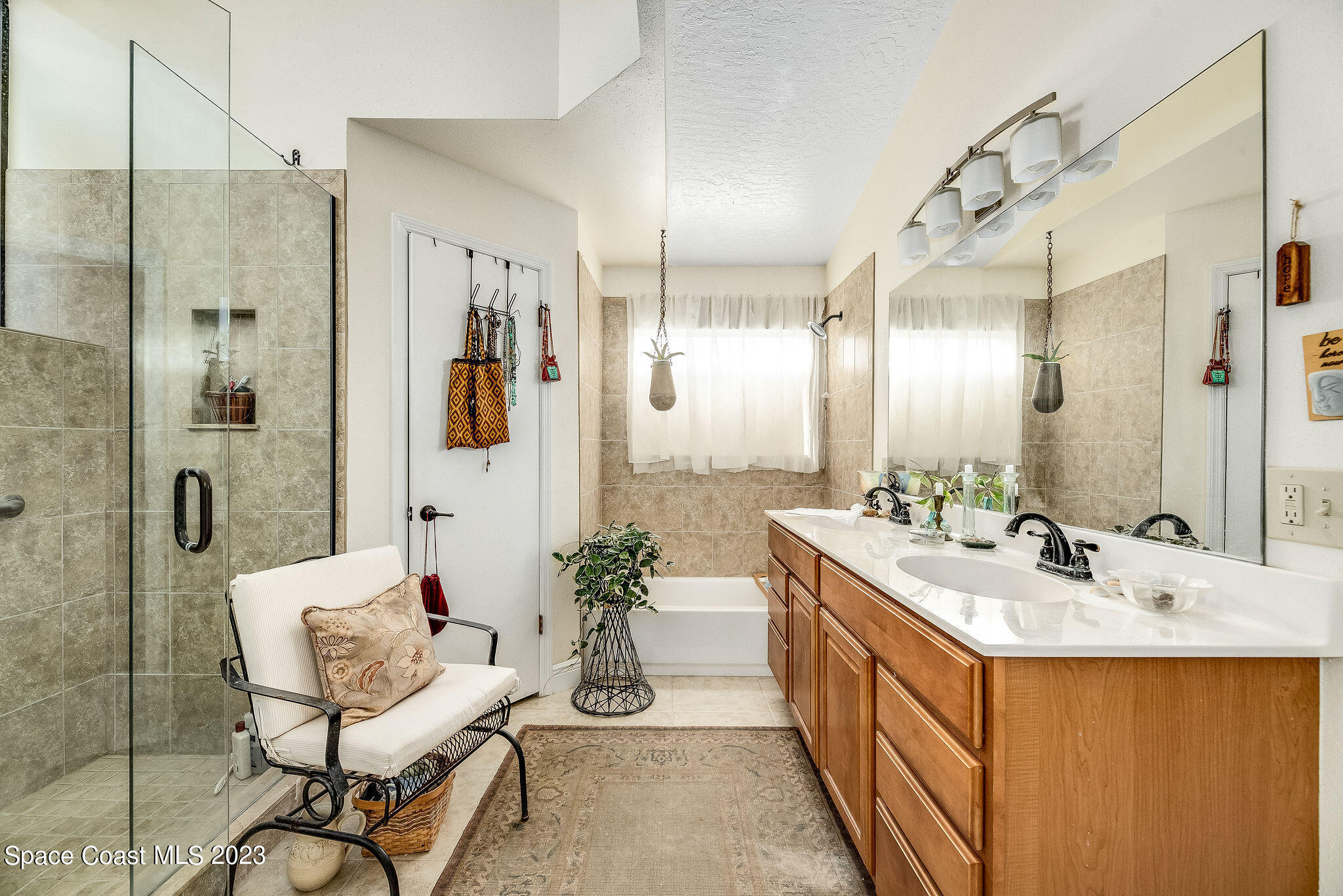 440 Maple Bluff Circle Melbourne, FL 32940 - Photo 33 of 92 a bathroom with a double vanity sink mirror and shower