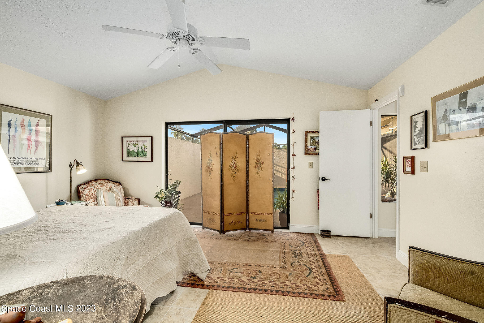 440 Maple Bluff Circle Melbourne, FL 32940 - Photo 38 of 92 a bedroom with a large bed and a chandelier