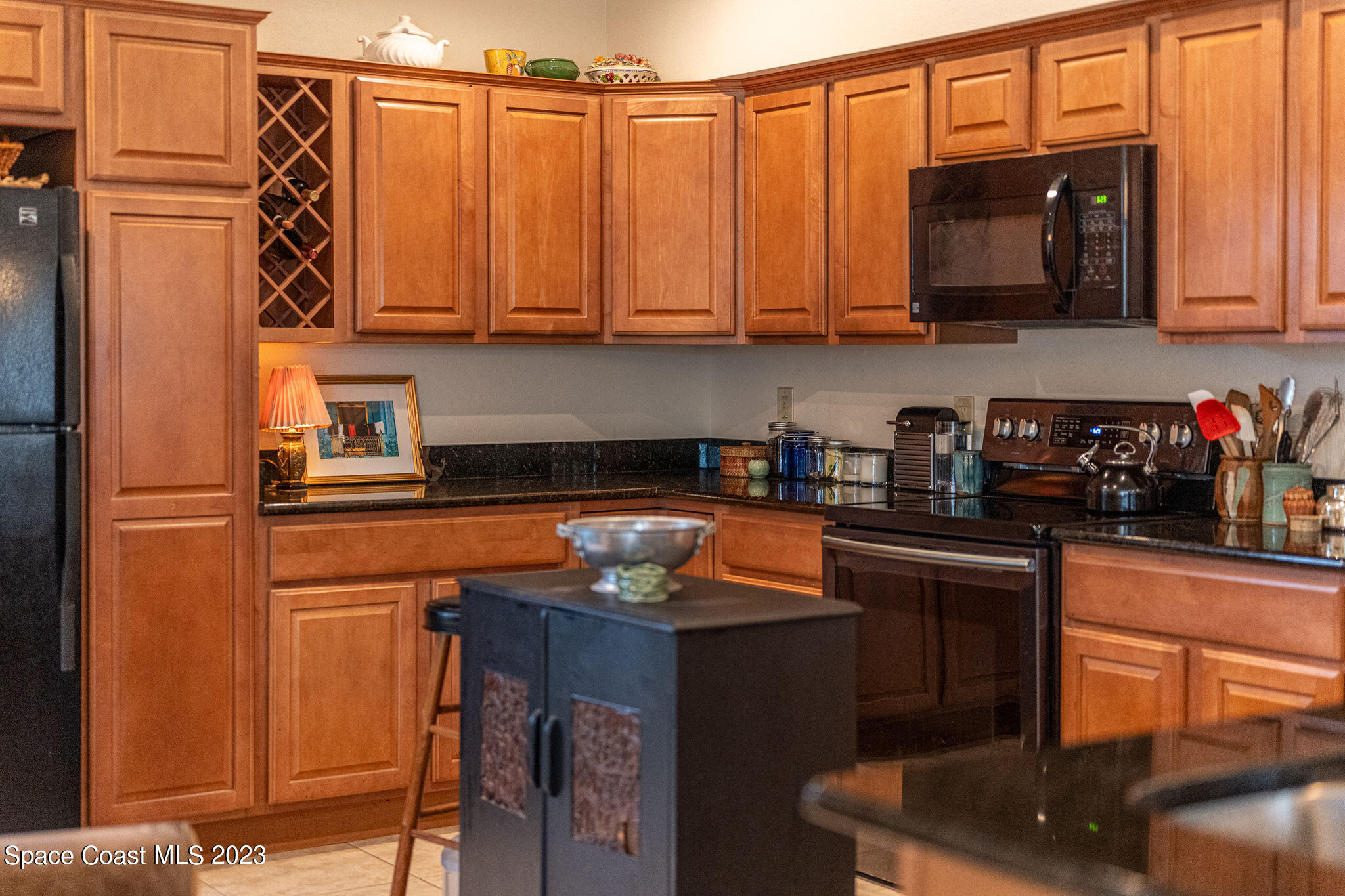 440 Maple Bluff Circle Melbourne, FL 32940 - Photo 57 of 92 a kitchen with stainless steel appliances granite countertop a refrigerator a stove a sink and dishwasher