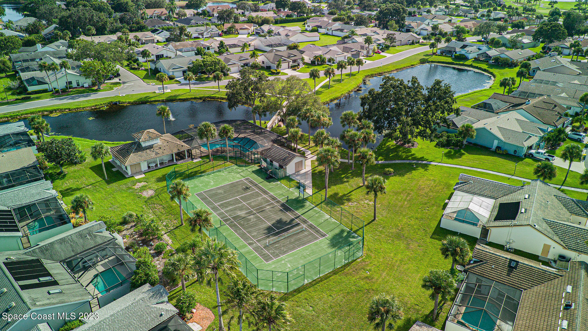 440 Maple Bluff Circle Melbourne, FL 32940 - Photo 80 of 92 a view of a lake with a building in the background