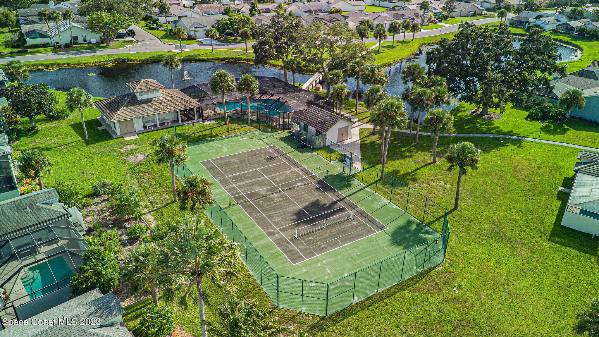 440 Maple Bluff Circle Melbourne, FL 32940 - Photo 81 of 92 an aerial view of a house with a garden and lake view