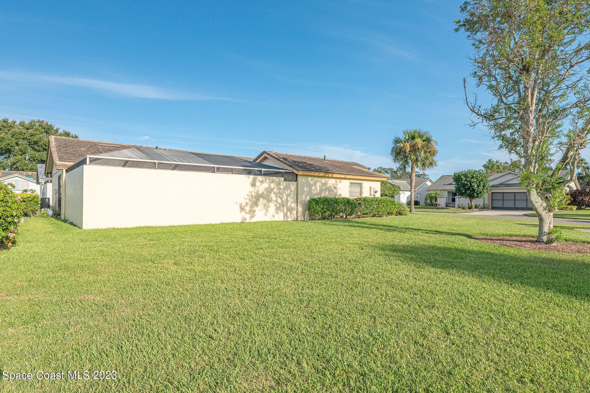 440 Maple Bluff Circle Melbourne, FL 32940 - Photo 88 of 92 a view of a big room with a big yard and potted plants