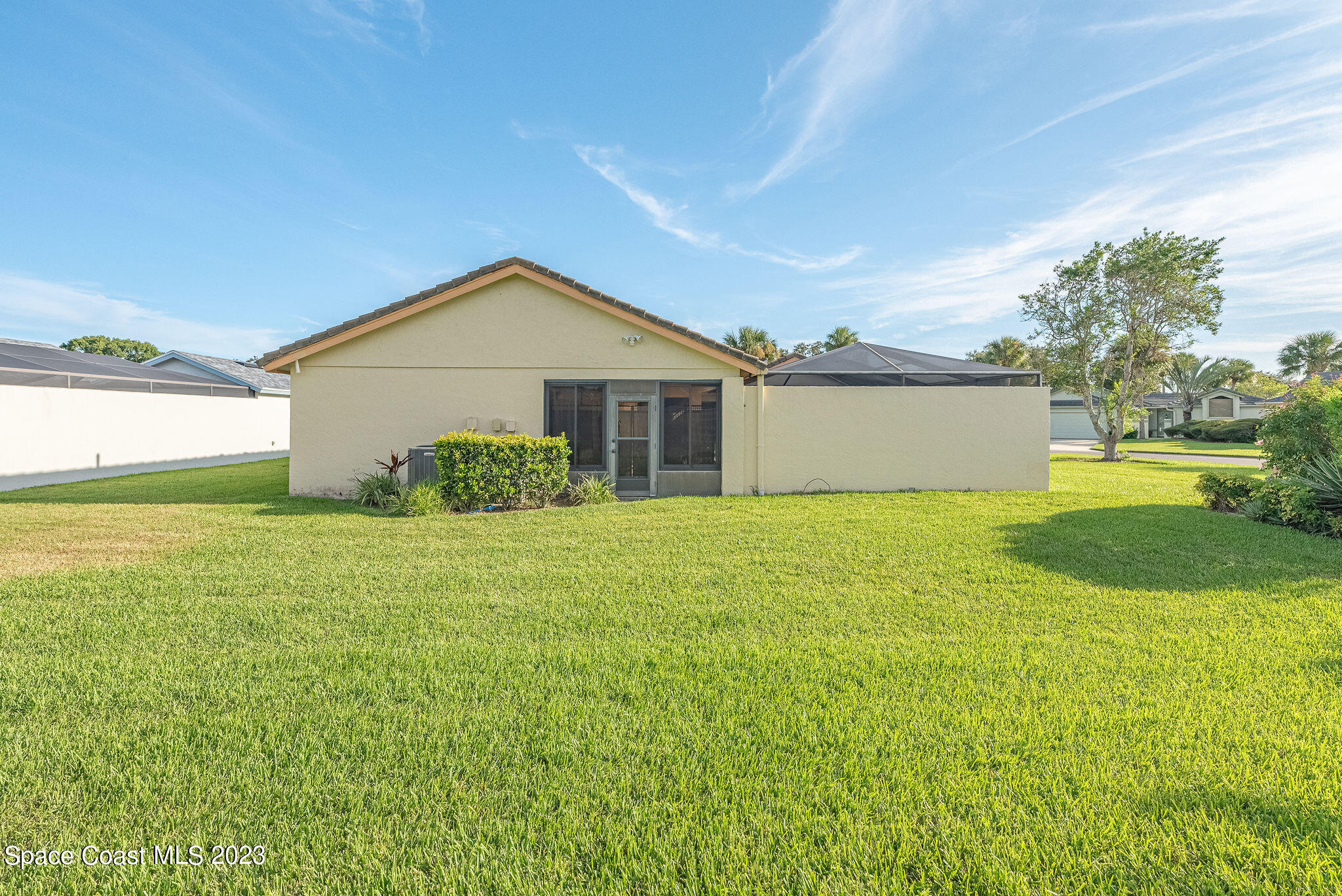 440 Maple Bluff Circle Melbourne, FL 32940 - Photo 90 of 92 a front view of a house with yard and green space