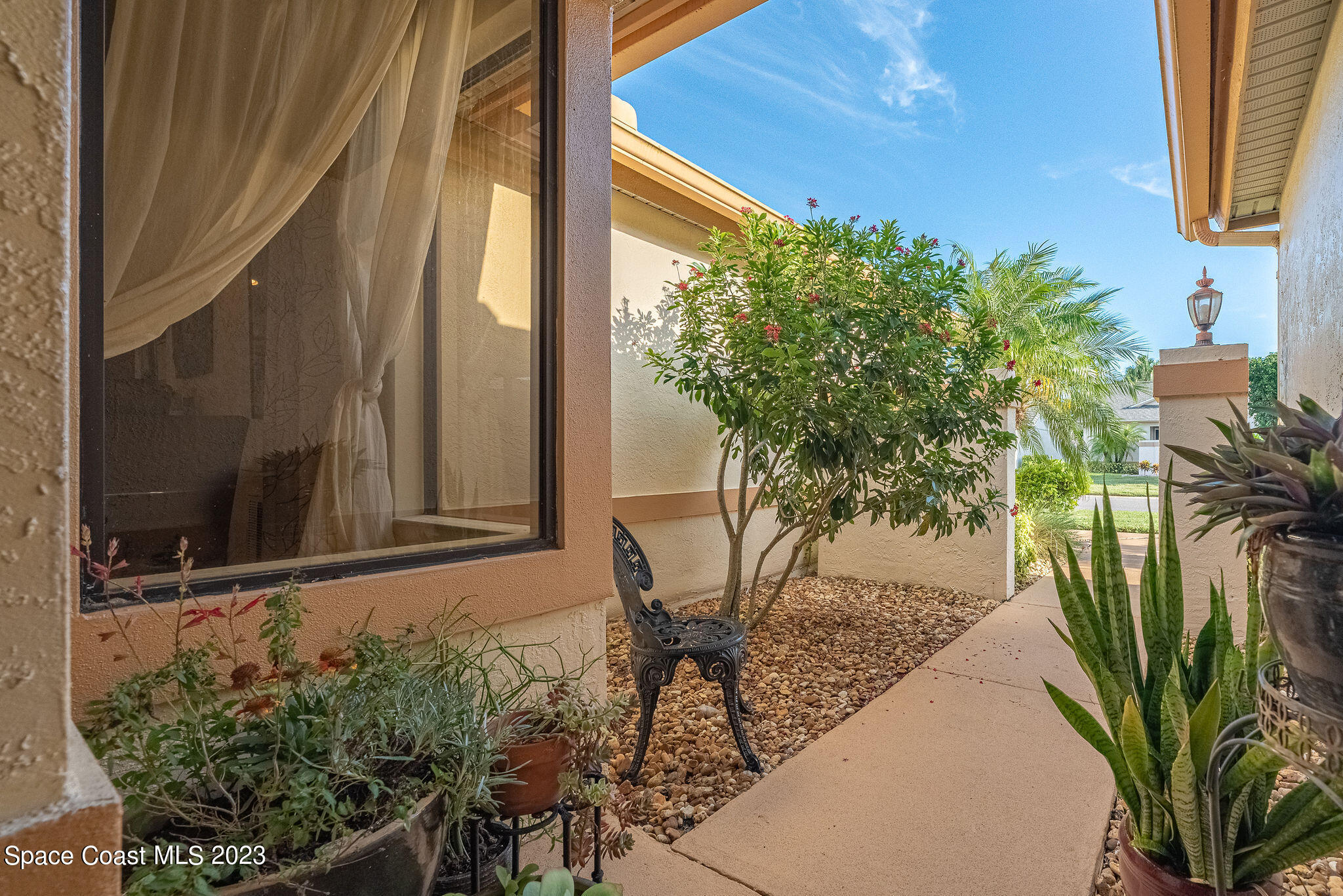 440 Maple Bluff Circle Melbourne, FL 32940 - Photo 9 of 92 a view of a potted plant in front of a door
