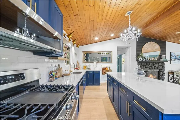 a kitchen with stove and cabinets
