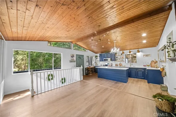 a view of a porch with furniture and wooden floor