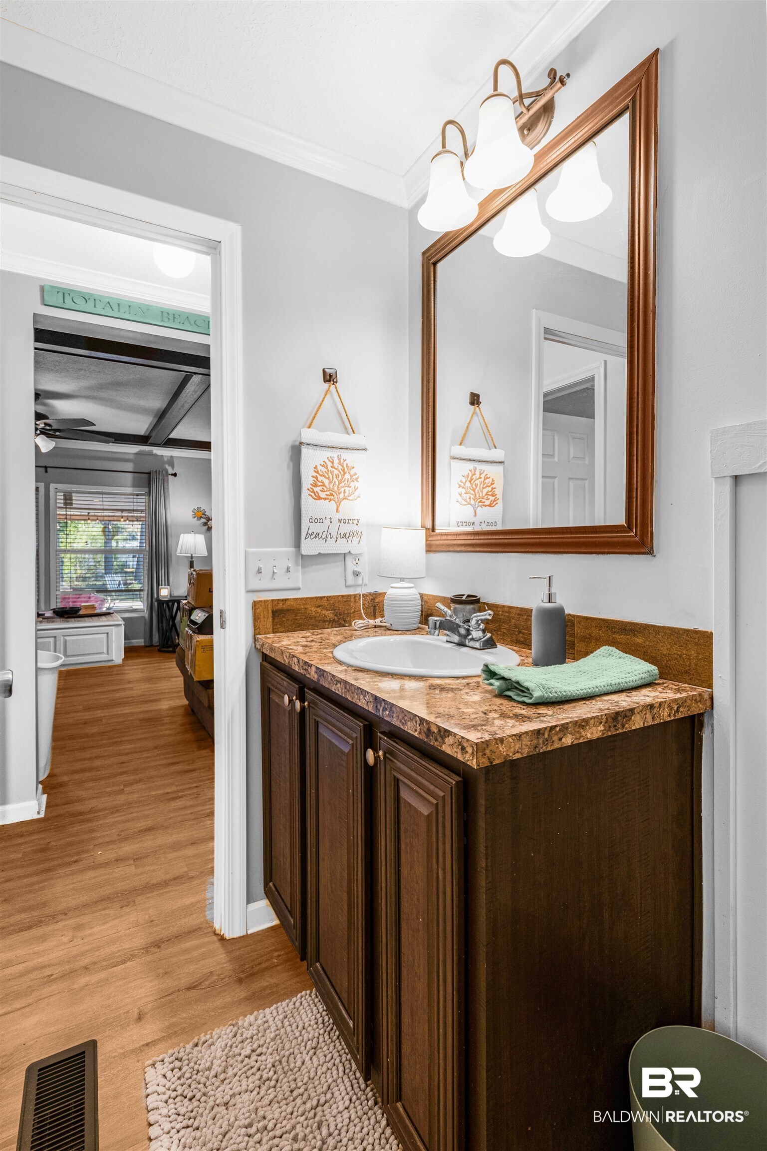 6921 Piney Woods Road Foley, AL 36535 - Photo 23 of 44 Bathroom with vanity, hardwood / wood-style flooring, and ornamental molding