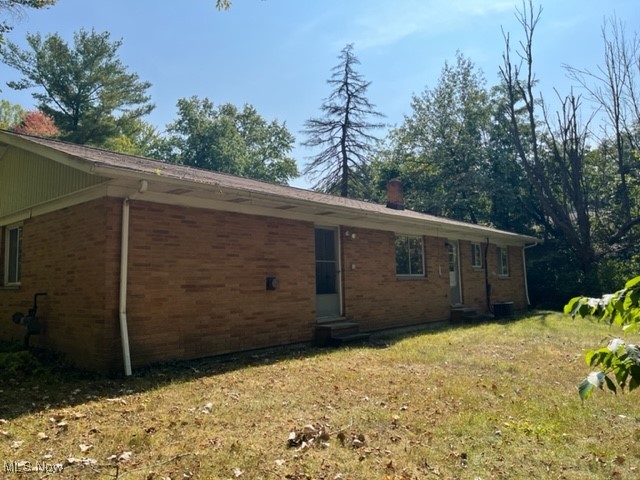 View of home's exterior with a yard